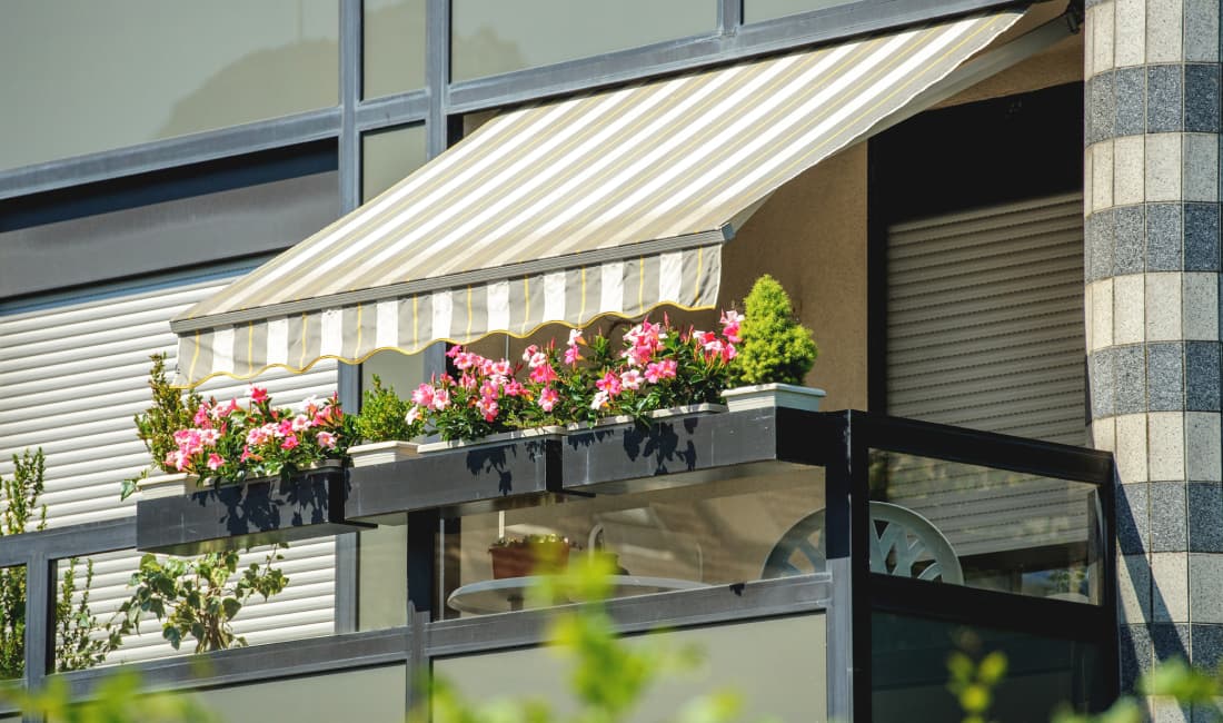 solar-powered retractable window awning over balcony